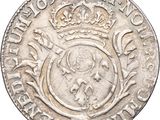 a close up of a silver coin with a crown on it
