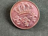 l'image d'une pièce de monnaie sur laquelle figure une couronne