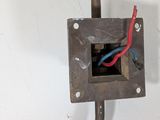a metal box with a red and blue wire attached to it