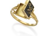 an image of a gold ring with a black stone in the center