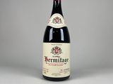 a bottle of red wine sitting on top of a table