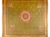 an antique chinese rug with a floral design on a green ground