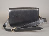 black leather cross body bag with gold hardware and strap