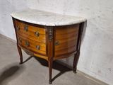 a marble top chest of drawers in a room
