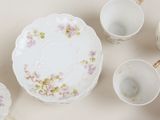 a lot of cups and saucers that are on the table