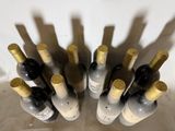 many bottles of wine sitting on a table together