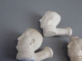 three figurines of a man and a woman on a table