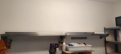 une cuisine équipée d'un micro-ondes et d'un lave-vaisselle posés sur le plan de travail
