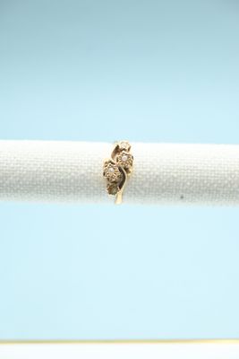 a close up of a gold ring on a white napkin