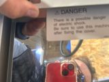 a man looking at a red iphone in a display case