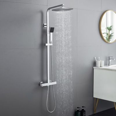 a close up of a shower head in a bathroom next to a sink