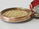 a medal with a ribbon around it on a table
