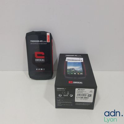 a cell phone that is sitting next to a box