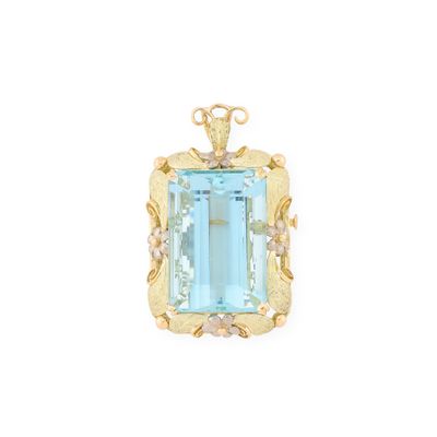 a close up of a blue topaz stone pendant on a white background