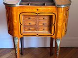 a small wooden table with a mirror on top of it