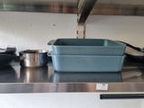 pots and pans sit on a stainless steel counter in a commercial kitchen