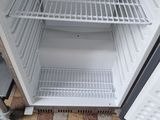 a cat that is standing in front of an open refrigerator