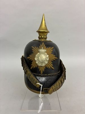 an old helmet with a gold star on it on a clear base
