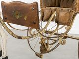 a horse pulling a carriage with a wooden seat