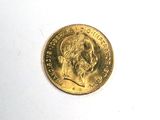 une pièce d'or sur laquelle figure l'image d'un homme