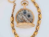 a gold pocket watch with a chain around it
