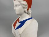 an image of a bust of a man wearing a red hat and blue and white shirt