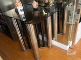 a glass table with a mirror on top of it in a room