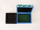 a small blue box with a green lid on a white surface
