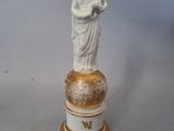 a statue of a woman holding a child on top of a pedestal