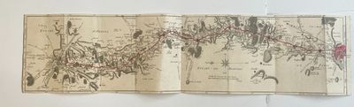 an old book with a map on it sitting on top of a table