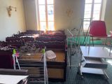 a room with a lot of chairs and tables in it
