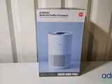 the box of a white air purifier sitting on top of a table