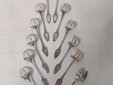 a lot of spoons and spoon spoons arranged in a shape of a christmas tree