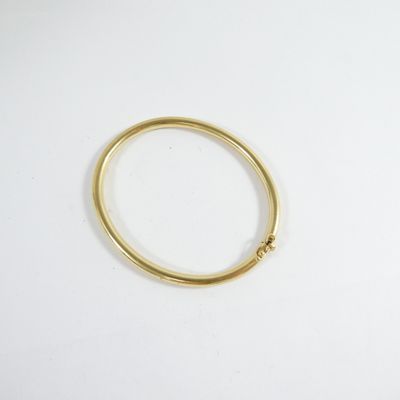 a close up of a gold ring on a white surface