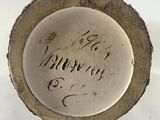 a white plate with writing on it sitting on a table