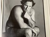 a black and white photo of a man sitting on a chair