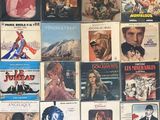 many different movie posters on the wall of a room