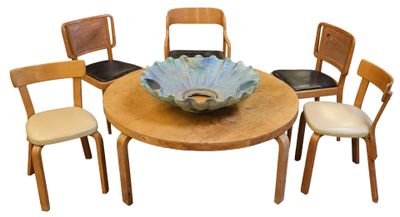 four chairs around a table with a bowl on it