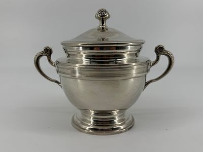 an antique silverplated sugar bowl with a lid and handles