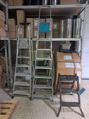 a lot of boxes and ladders in a garage