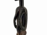 an image of a wooden statue of a man with a hat on his head