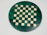 a green and white chess board on a white table