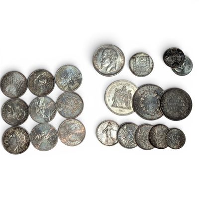 some old coins are laying out on a white surface