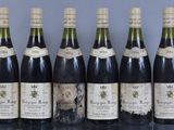 several bottles of wine are lined up on a table