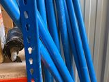 a pile of blue plastic pipes sitting on a shelf
