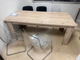 a wooden table and two chairs in a room