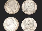 a group of four silver coins with the faces of two men and one woman