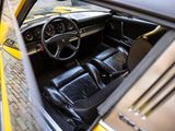 a yellow car with black leather seats and a steering wheel