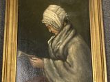 une peinture à l'huile représentant une femme en train de lire un livre, dans un cadre doré