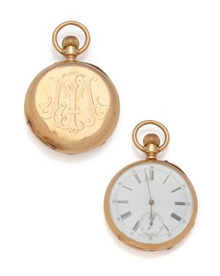 two gold pocket watches sitting next to each other on a white surface